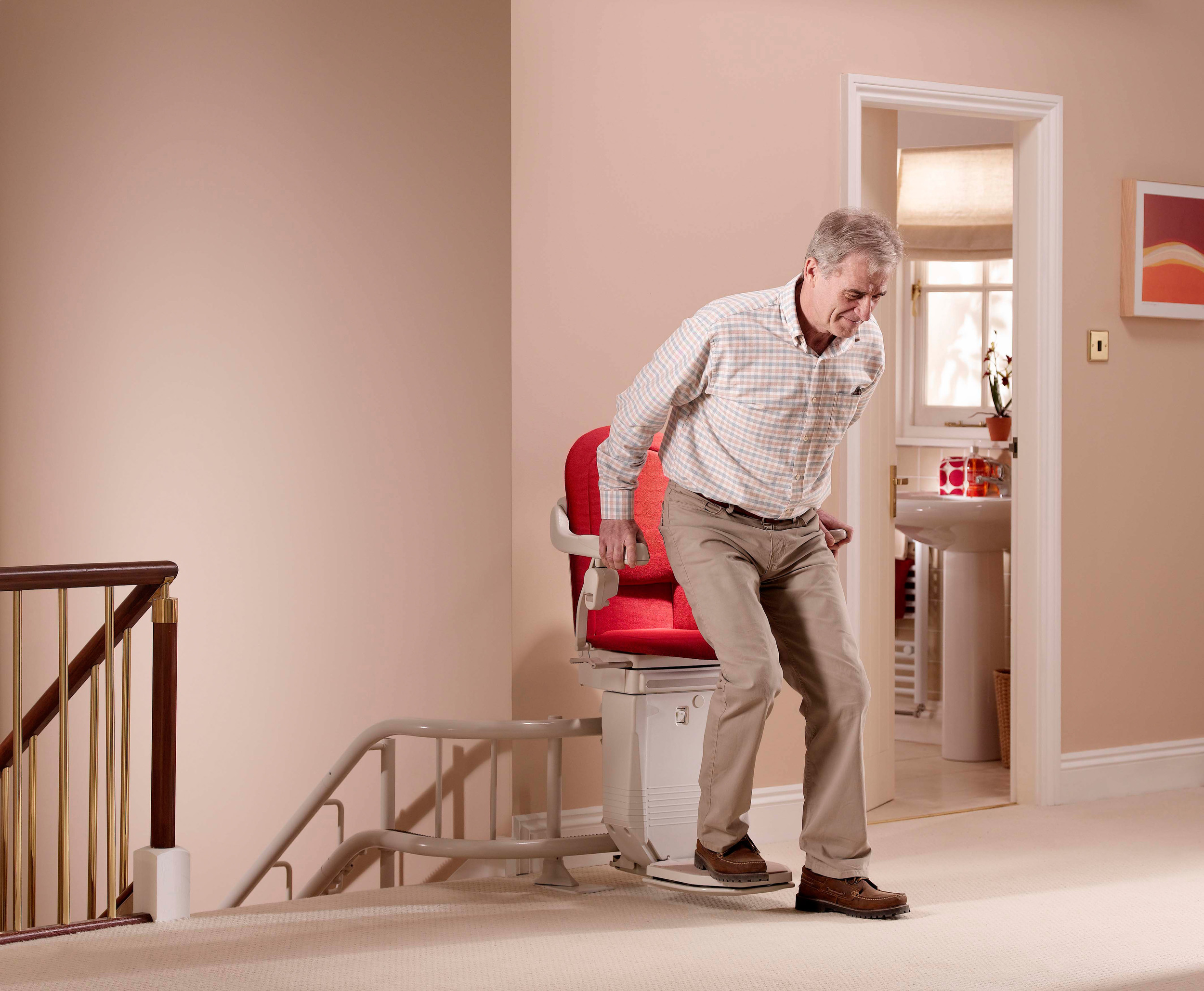 Exiting a Curved Stair Lift Red Sofia Stair Lift